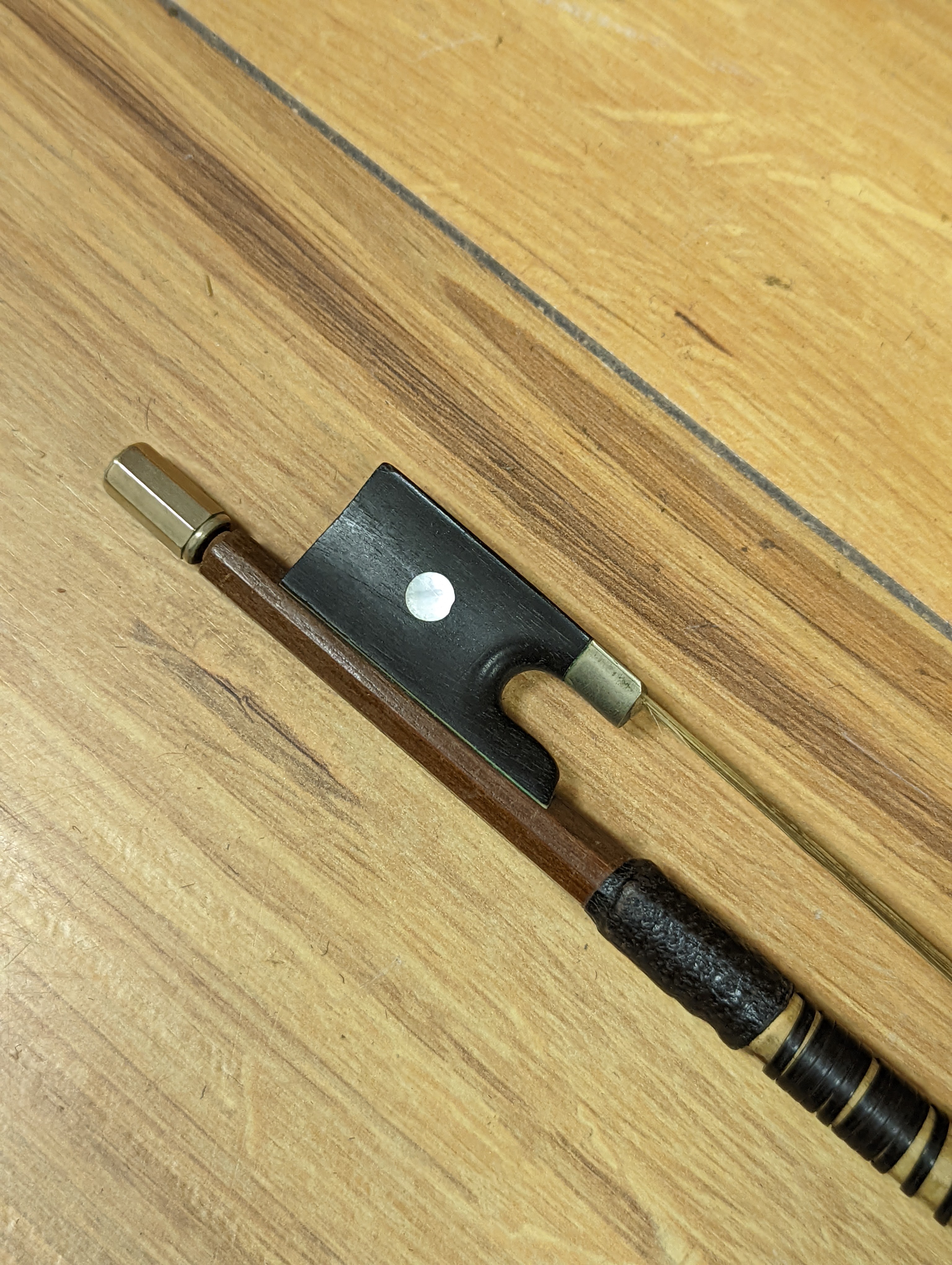 An early 20th century French vioilin, cased with bow and a cased saxon violin